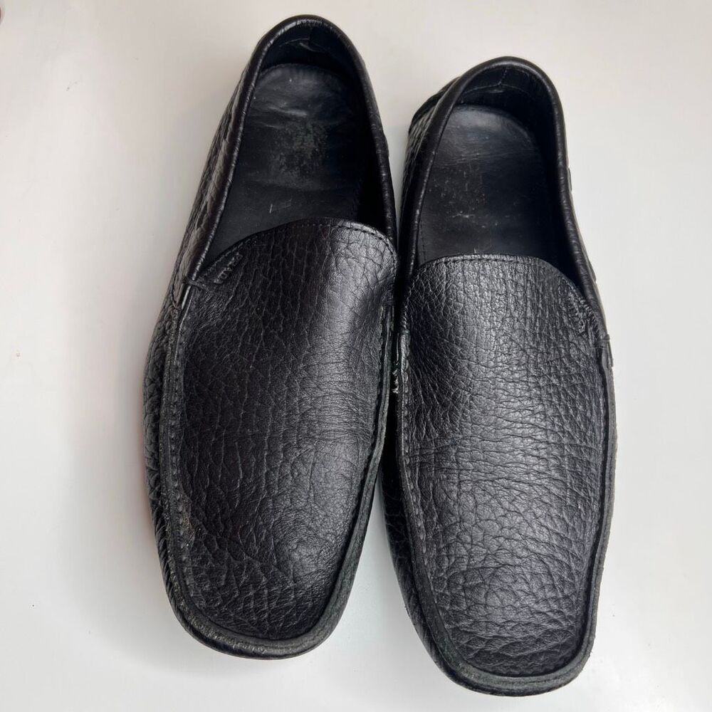 Prada black pebbled leather slip-on driving loafers appear to be a model